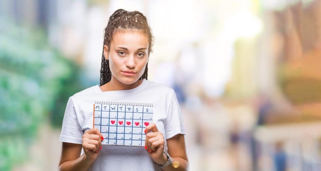 Teenage girl holding a calendar after irregular menstruation treatment by Dr. Joshua Smith, a pediatric endocrinologist in Pocatello and Idaho Falls.