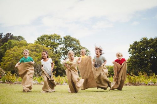 Children with diabetes compete in a camp gunny-sack race.