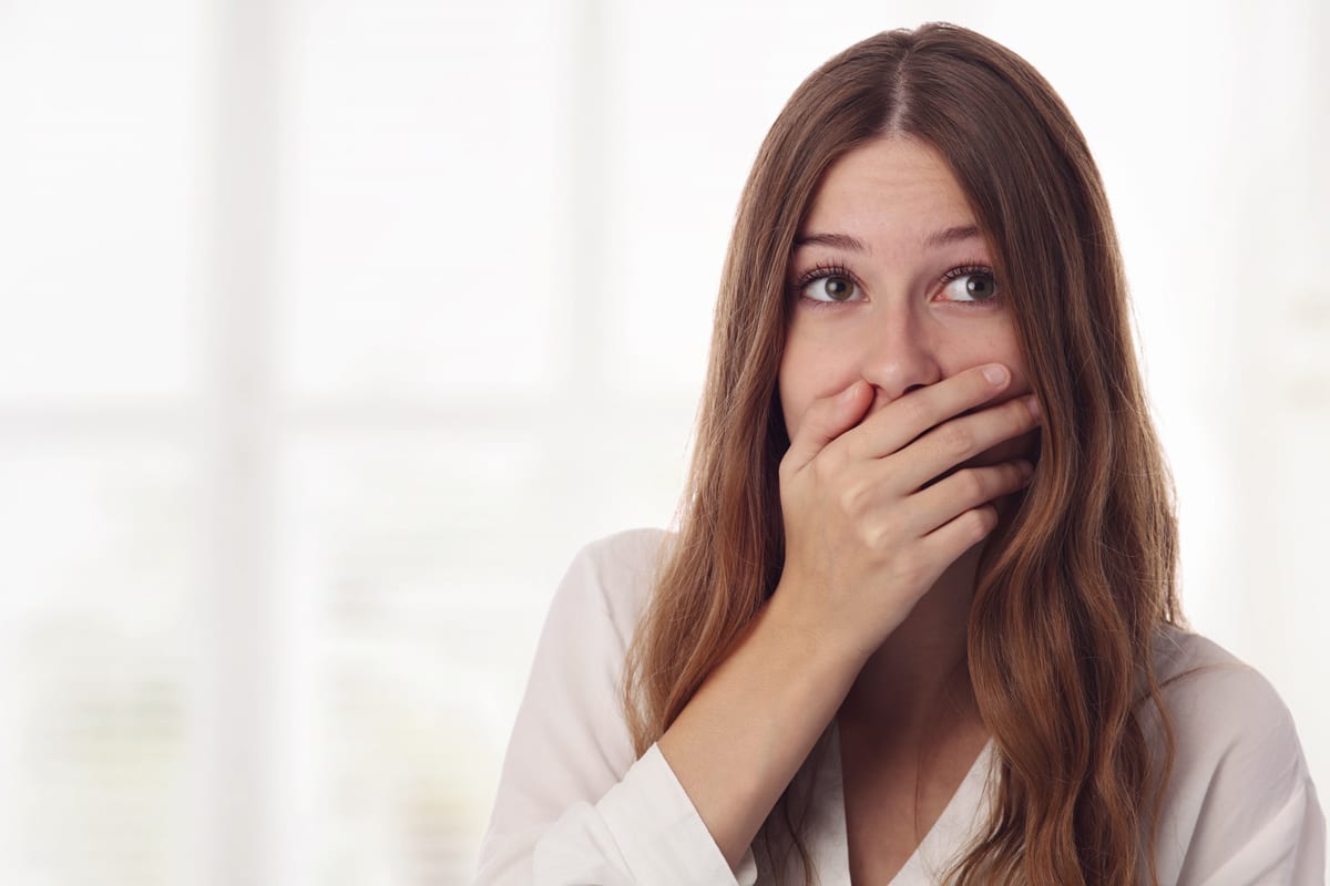 A woman covering her mouth recognizing a mistake in appointments with her diabetes doctor in Idaho Falls or Pocatello. 