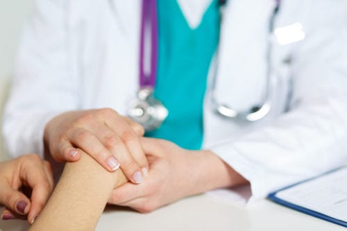 Caring diabetes doctor holding the hand of a patient at Rocky Mountain Diabetes center in Idaho Falls and Pocatello